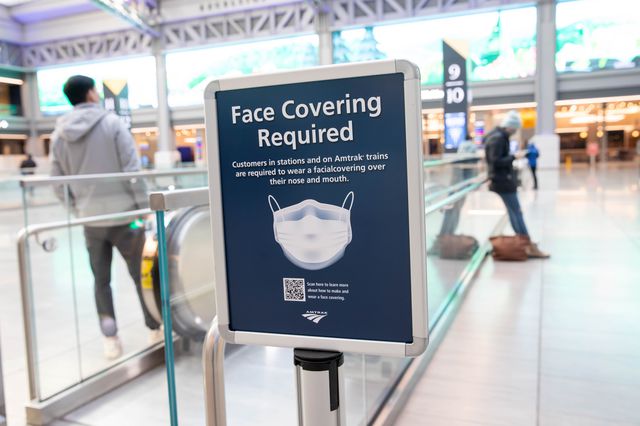 A sign advertising a face mask requirement is displayed at the Moynihan Train Hall in New York City.